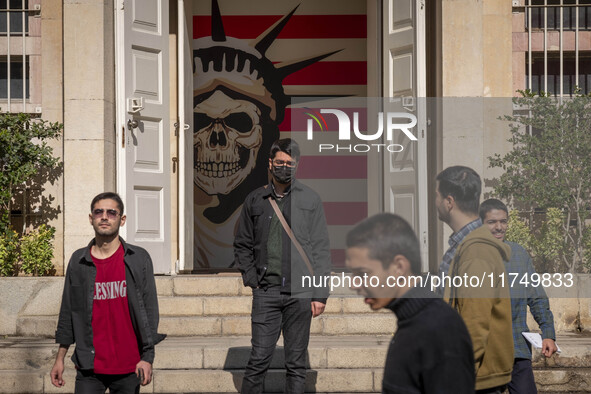 A group of Iranian men stands together in front of an anti-U.S. mural at the former U.S. embassy in Tehran, Iran, on November 7, 2024. Forme...