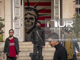 A group of Iranian men stands together in front of an anti-U.S. mural at the former U.S. embassy in Tehran, Iran, on November 7, 2024. Forme...