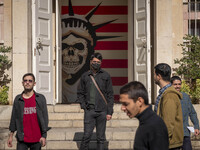 A group of Iranian men stands together in front of an anti-U.S. mural at the former U.S. embassy in Tehran, Iran, on November 7, 2024. Forme...