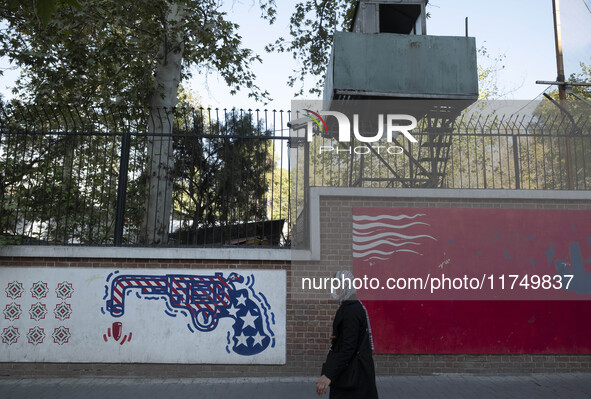 An Iranian woman walks past anti-U.S. murals on a wall of the former U.S. embassy in Tehran, Iran, on November 7, 2024. Former U.S. Presiden...