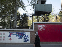 An Iranian woman walks past anti-U.S. murals on a wall of the former U.S. embassy in Tehran, Iran, on November 7, 2024. Former U.S. Presiden...