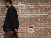 An Iranian man walks past anti-U.S. sculptures on a wall of the former U.S. embassy in Tehran, Iran, on November 7, 2024. Former U.S. Presid...