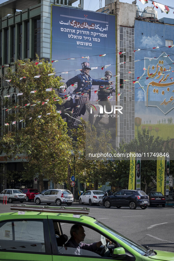 An Iranian taxi driver drives his taxi under an anti-U.S. and Israeli banner in downtown Tehran, Iran, on November 7, 2024. Former U.S. Pres...