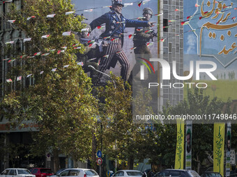 An Iranian taxi driver drives his taxi under an anti-U.S. and Israeli banner in downtown Tehran, Iran, on November 7, 2024. Former U.S. Pres...