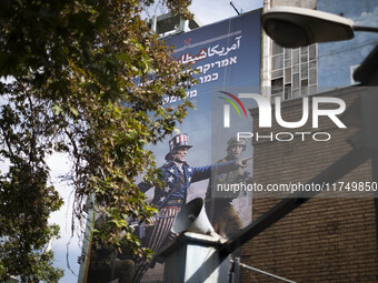 An anti-U.S. and Israeli banner hangs from a wall of a governmental building in downtown Tehran, Iran, on November 7, 2024. Former U.S. Pres...