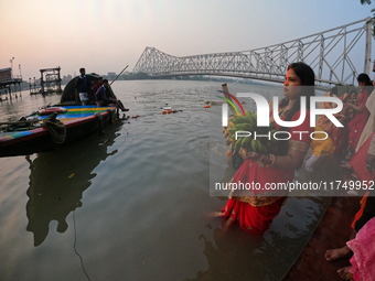 A Hindu devotee offers prayers to the sun god during The Chhath Festival at the Ganga ghat in Kolkata, India, on November 7, 2024. The Chhat...