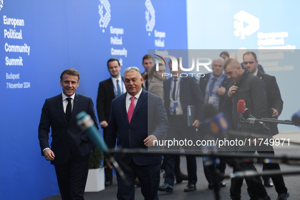 Emmanuel Macron, President of France, arrives with Viktor Orban, Hungarian Prime Minister, at the 5th European Political Community Summit in...