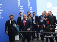 Emmanuel Macron, President of France, arrives with Viktor Orban, Hungarian Prime Minister, at the 5th European Political Community Summit in...