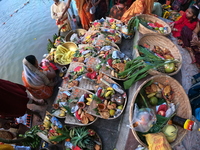 A Hindu devotee offers prayers to the sun god during the Chhath Festival at the Ganga ghat and the backside of Howrah Bridge in Kolkata, Ind...