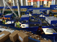 Employees of China Post Express Logistics sort express parcels at an intelligent automatic line in Fuyang, China, on November 7, 2024. (