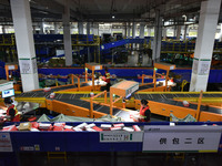 Employees of China Post Express Logistics sort express parcels at an intelligent automatic line in Fuyang, China, on November 7, 2024. (