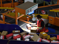 Employees of China Post Express Logistics sort express parcels at an intelligent automatic line in Fuyang, China, on November 7, 2024. (