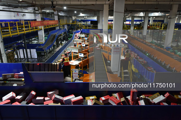 Employees of China Post Express Logistics sort express parcels at an intelligent automatic line in Fuyang, China, on November 7, 2024. 