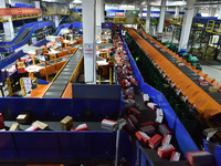 Employees of China Post Express Logistics sort express parcels at an intelligent automatic line in Fuyang, China, on November 7, 2024. (