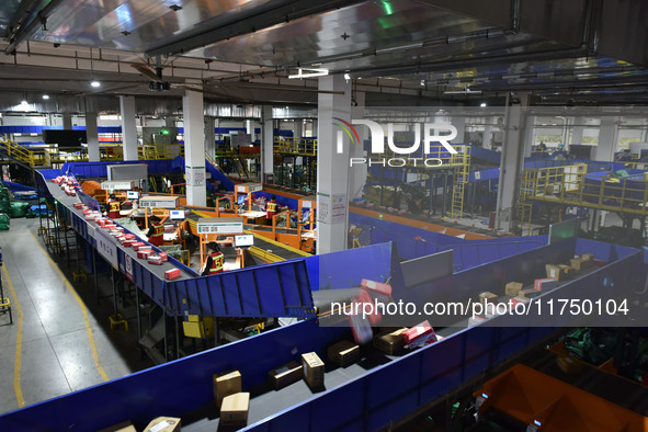 Employees of China Post Express Logistics sort express parcels at an intelligent automatic line in Fuyang, China, on November 7, 2024. 