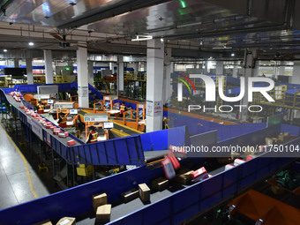 Employees of China Post Express Logistics sort express parcels at an intelligent automatic line in Fuyang, China, on November 7, 2024. (