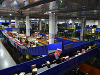 Employees of China Post Express Logistics sort express parcels at an intelligent automatic line in Fuyang, China, on November 7, 2024. (