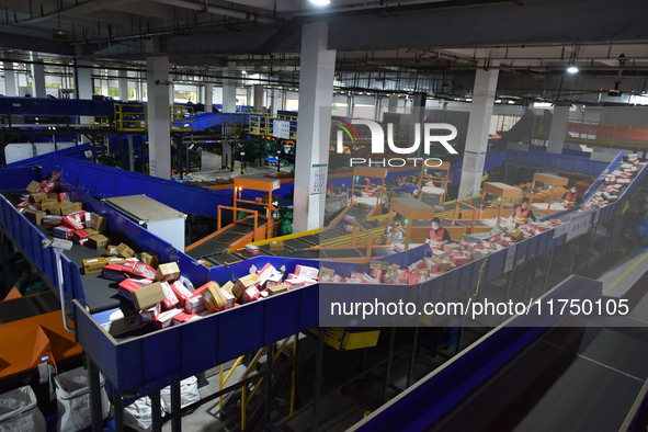 Employees of China Post Express Logistics sort express parcels at an intelligent automatic line in Fuyang, China, on November 7, 2024. 