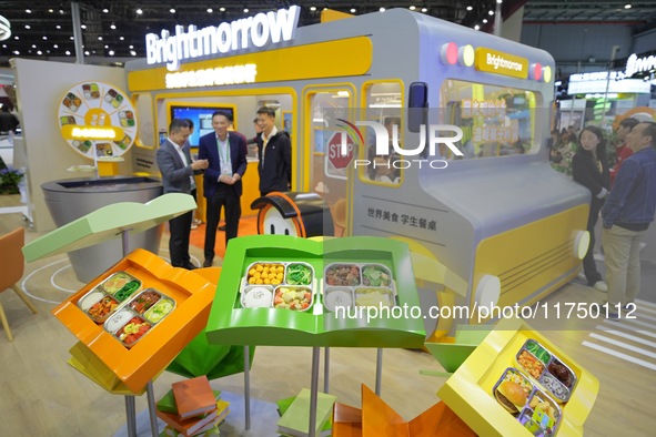 Visitors visit the booth of Guangming School Food at the 7th CIIE in Shanghai, China, on November 7, 2024. 