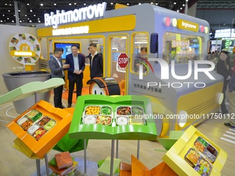 Visitors visit the booth of Guangming School Food at the 7th CIIE in Shanghai, China, on November 7, 2024. (