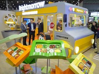 Visitors visit the booth of Guangming School Food at the 7th CIIE in Shanghai, China, on November 7, 2024. (