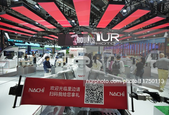 A twin-wrist robot welcomes visitors at the Nachi booth of the 7th CIIE in Shanghai, China, on November 7, 2024. 