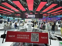 A twin-wrist robot welcomes visitors at the Nachi booth of the 7th CIIE in Shanghai, China, on November 7, 2024. (