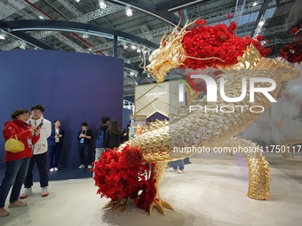 Visitors visit the Guerlain booth at the 7th CIIE in Shanghai, China, on November 7, 2024. (