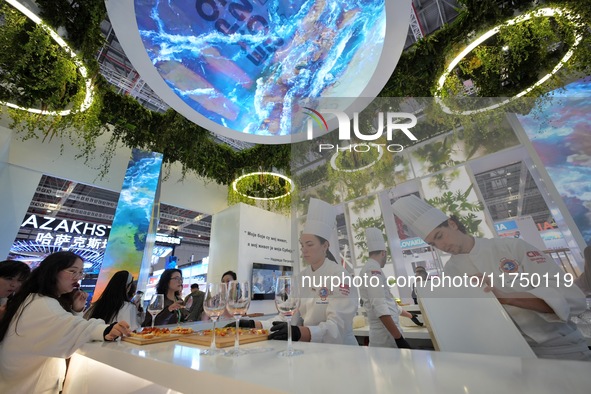 The audience tastes food at the Serbian National Pavilion of the 7th CIIE in Shanghai, China, on November 7, 2024. 