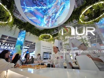 The audience tastes food at the Serbian National Pavilion of the 7th CIIE in Shanghai, China, on November 7, 2024. (