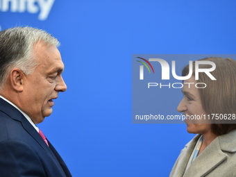 Maia Sandu, President of Moldova, is greeted by Viktor Orban, Hungarian Prime Minister, before the 5th European Political Community Summit i...