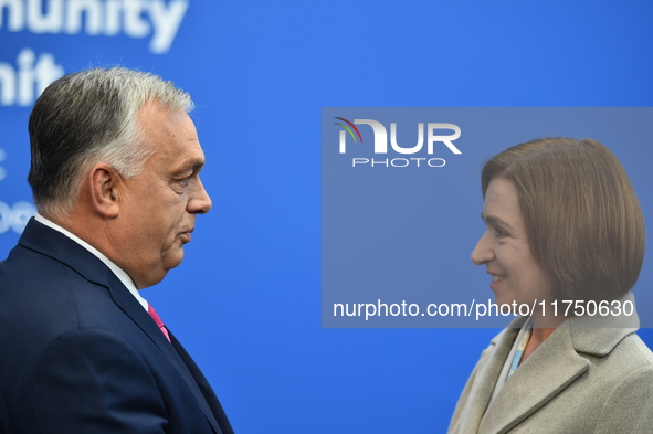 Maia Sandu, President of Moldova, is greeted by Viktor Orban, Hungarian Prime Minister, before the 5th European Political Community Summit i...