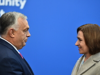 Maia Sandu, President of Moldova, is greeted by Viktor Orban, Hungarian Prime Minister, before the 5th European Political Community Summit i...