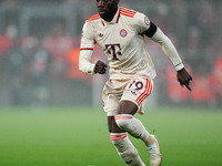 Alphonso Davies of Bayern Munich  controls the ball during the Champions League Round 4 match between Bayern Munich v Benfica at the Allianz...