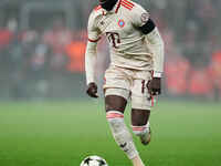 Alphonso Davies of Bayern Munich  controls the ball during the Champions League Round 4 match between Bayern Munich v Benfica at the Allianz...