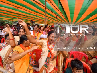 Supporters of the Bharatiya Janata Party (BJP) participate in an election campaign rally in support of BJP candidate Diplu Ranjan Sarmah fro...