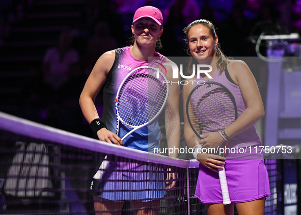 RIYADH, SAUDI ARABIA - NOVEMBER 07: Iga Swiatek (L) of Poland pose for a photo with Daria Kasatkina (R), on Day 6 of the 2024 WTA Finals, pa...