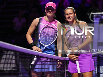 RIYADH, SAUDI ARABIA - NOVEMBER 07: Iga Swiatek (L) of Poland pose for a photo with Daria Kasatkina (R), on Day 6 of the 2024 WTA Finals, pa...