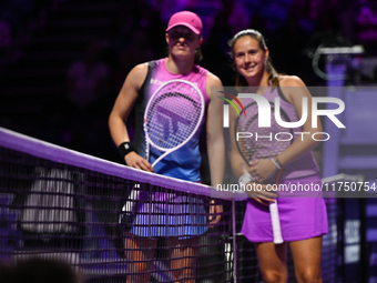 RIYADH, SAUDI ARABIA - NOVEMBER 07: Iga Swiatek (L) of Poland pose for a photo with Daria Kasatkina (R), on Day 6 of the 2024 WTA Finals, pa...