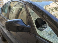 A close-up shot of a car with a shattered side window results from an attempted theft in Bari, Italy, on November 6, 2024. This image highli...