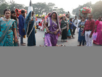 A Hindu woman steps over children in a ritual seeking blessings for the child from the Sun god during the religious festival of Chhat Puja i...