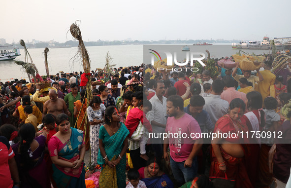 Hindu devotees hold offerings as they worship the Sun god on the banks of the river Ganges during the religious festival of Chhat Puja in Ko...