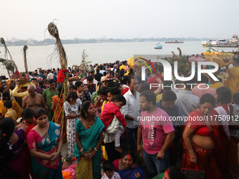 Hindu devotees hold offerings as they worship the Sun god on the banks of the river Ganges during the religious festival of Chhat Puja in Ko...