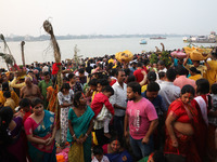 Hindu devotees hold offerings as they worship the Sun god on the banks of the river Ganges during the religious festival of Chhat Puja in Ko...