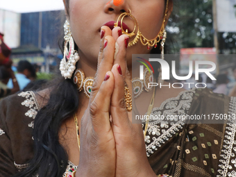 A Hindu woman worships the Sun god Surya on the banks of the river Ganges during the Hindu religious festival of Chhat Puja in Kolkata, Indi...