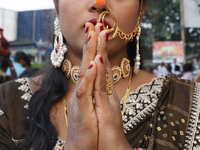 A Hindu woman worships the Sun god Surya on the banks of the river Ganges during the Hindu religious festival of Chhat Puja in Kolkata, Indi...