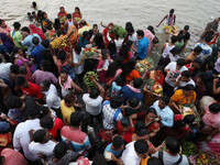 Hindu devotees hold offerings as they worship the Sun god on the banks of the river Ganges during the religious festival of Chhat Puja in Ko...