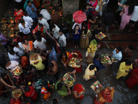 Hindu devotees hold offerings as they worship the Sun god on the banks of the river Ganges during the religious festival of Chhat Puja in Ko...