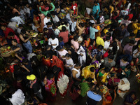 Hindu devotees hold offerings as they worship the Sun god on the banks of the river Ganges during the religious festival of Chhat Puja in Ko...