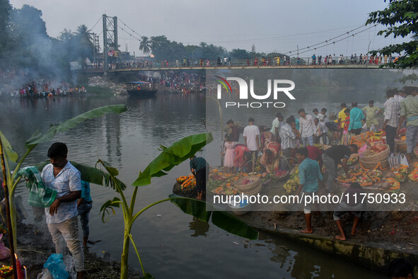 Devotees offer prayers to the sun god at a riverside 70 kilometers outside of Kolkata, India, on November 7, 2024, during the Chhath Puja fe...